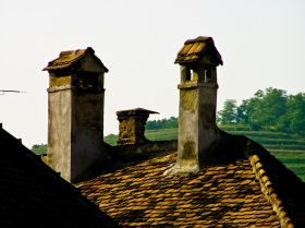 Old brick chimneys on the roof of one of the old houses in the historic city center, Medias, Romania.